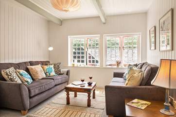 The sitting-room looks out over the shared courtyard garden below.
