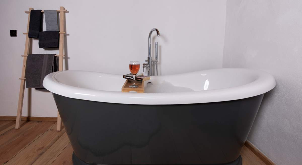 Sit back and relax in the roll-top bath - with a glass of wine and book in hand. 