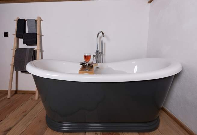 Sit back and relax in the roll-top bath - with a glass of wine and book in hand. 