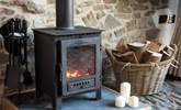 The warming wood-burner ensures year-round cosiness and adds a lovely atmosphere to out-of-season breaks. - Thumbnail Image