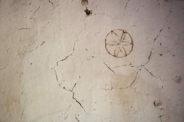 Spot the medieval patterns engraved into the cob walls, carved to welcome in good fortune and fend off witchcraft.