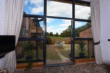 The patio doors and surrounding windows allow the natural light to flood in.