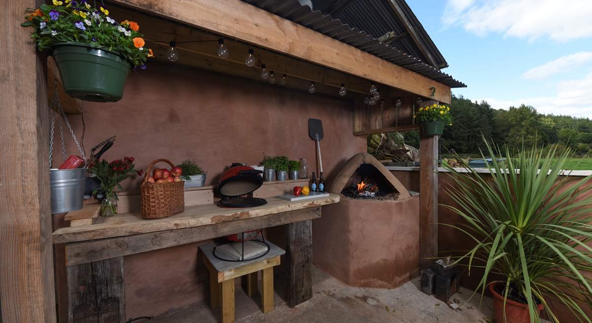 Not only is there a Kamado (barbecue and ceramic smoker) but there's a wood-fired pizza oven too!