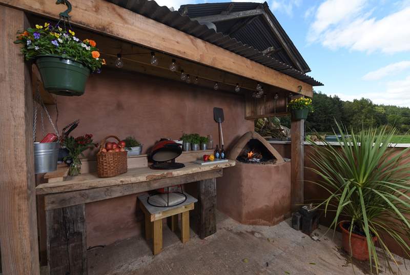 Not only is there a Kamado (barbecue and ceramic smoker) but there's a wood-fired pizza oven too!