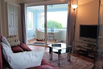 The sun-room has views to Praa Sands and the sea beyond.