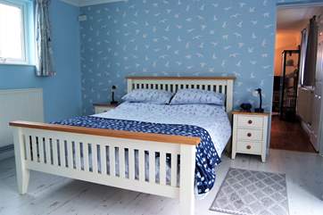 The bedroom is spacious and comfortable.