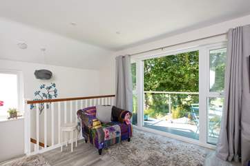 Stairs lead up from the kitchen diner to the sitting-room, which opens onto the balcony.