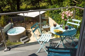 The balcony overlooks the hot tub and terrace.