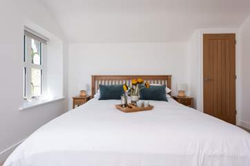 A super-king size Hypnos bed. The door to the right hand side of the bed leads into a walk in wardrobe/dressing-room.