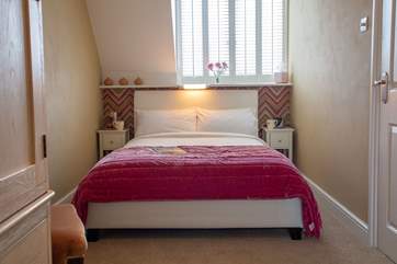 The warmly decorated second double bedroom.