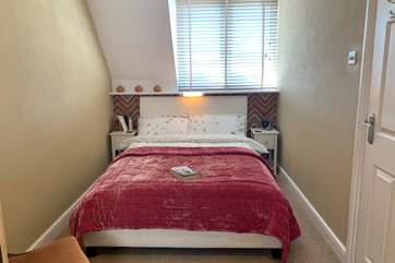 The warmly decorated second double bedroom.