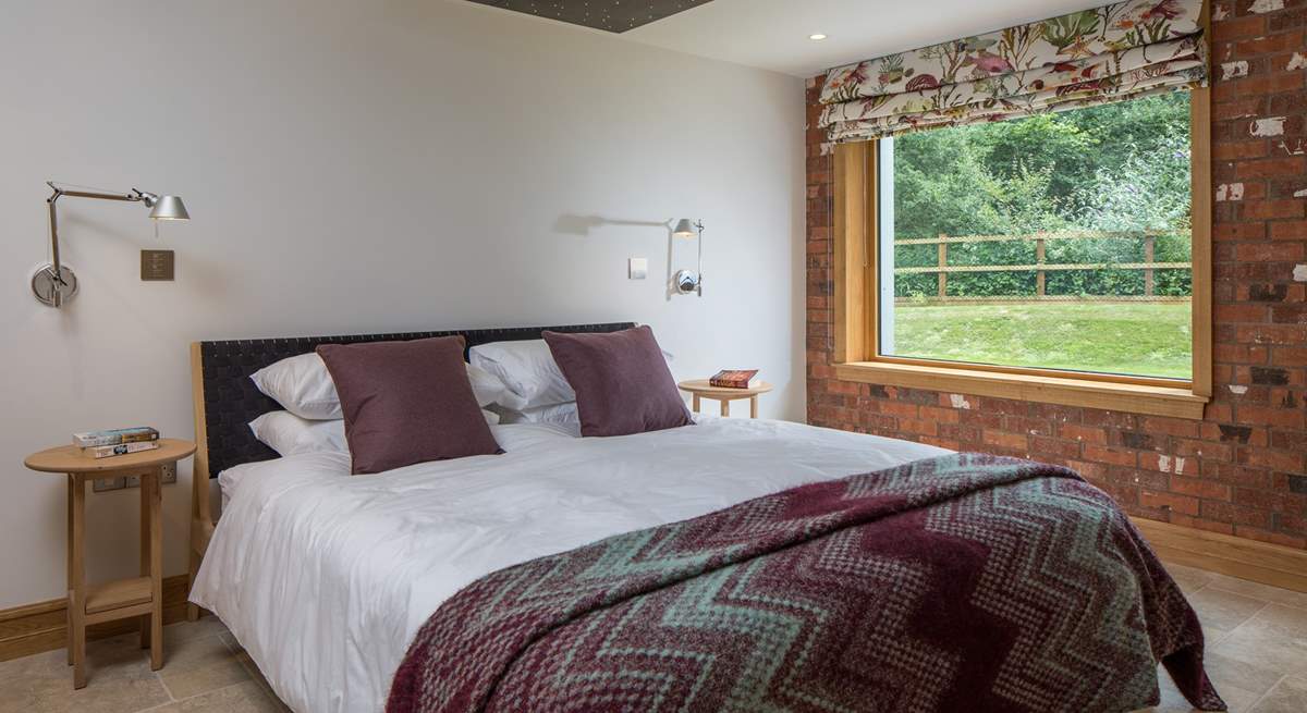 Bedroom 1 offers this fabulous super-king size bed with views out over the garden and into the woodland.