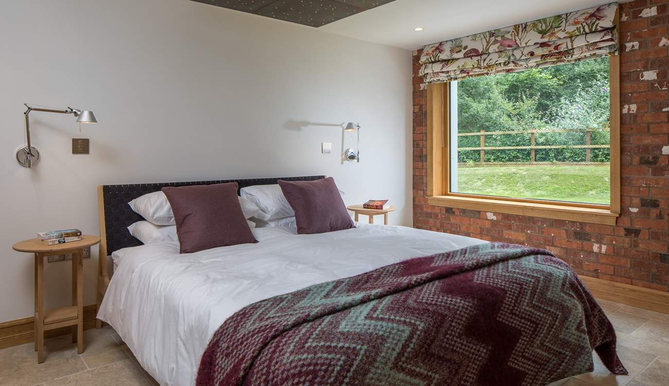 Bedroom 1 offers this fabulous super-king size bed with views out over the garden and into the woodland.