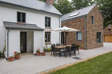 The games-room/garage is neatly tucked away across the driveway (right of shot).