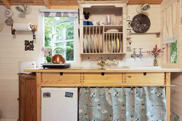 The small but perfectly formed kitchen is complete with two-ring hob, fridge and a fully-stocked inventory.