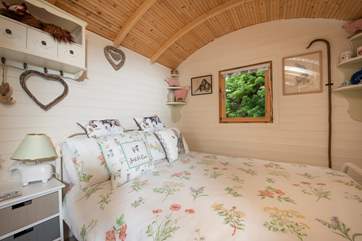The double bed is adorned with beautiful linens and ensures a restful night's sleep, ready for the next day's adventures.