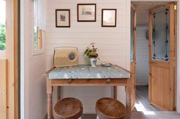 The sweet dining area, with retro radio - a perfect to pop on whilst rustling up breakfast.