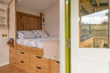 The comfy king-size bed is tucked into one end of the cabin.