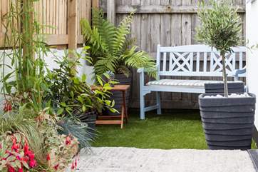The enclosed garden is full of colour in the summer months.