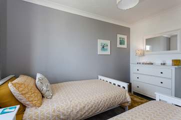 Bedroom 2 is beautifully styled in sweet yellow and grey.