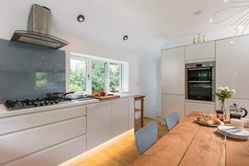 The stairs in the kitchen lead down to the bedrooms and bathrooms.