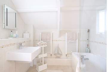 The spacious bathroom is located on the mezzanine level.