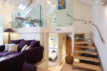Open tread stairs lead up to the mezzanine dining-area and bathroom.