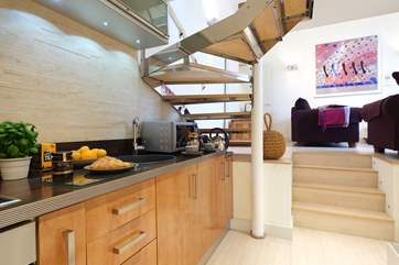 A small flight of stairs lead down to the kitchen and bedroom.