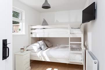 Bedroom 1 is located on the ground floor, and looks out onto the rear patio. The bunk-beds host a four-foot small double on the bottom and single on the top. Perfect for the bigger ones!