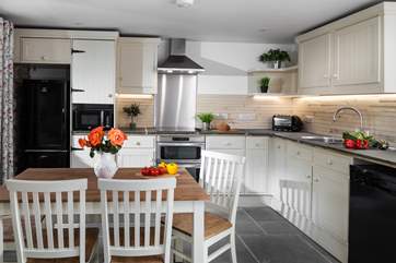 The open plan kitchen/diner hosts a hand-crafted kitchen.
