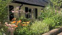 The Coach House is embraced with beautiful flower borders and has its own beautiful gardens, set within the grounds of a country house. There are a couple of steps down to the front door and then one up. 