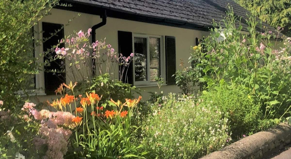 The Coach House is embraced with beautiful flower borders and has its own beautiful gardens, set within the grounds of a country house. There are a couple of steps down to the front door and then one up. 