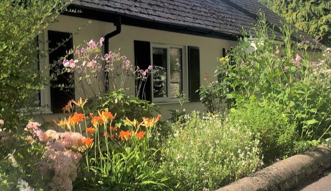 The Coach House is embraced with beautiful flower borders and has its own beautiful gardens, set within the grounds of a country house. There are a couple of steps down to the front door and then one up. 