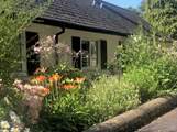 The Coach House is embraced with beautiful flower borders and has its own beautiful gardens, set within the grounds of a country house. There are a couple of steps down to the front door and then one up.