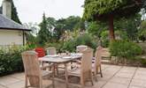 The stone terrace has beautifully planted borders and French windows from the living-area, lead straight out onto it. You can see the corner of the owner's home next door - The Coach House is on a higher level and tucked behind it. - Thumbnail Image