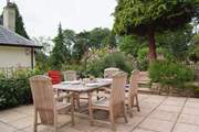 The stone terrace has beautifully planted borders and French windows from the living-area, lead straight out onto it. You can see the corner of the owner's home next door - The Coach House is on a higher level and tucked behind it.