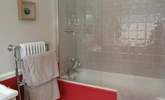 The en suite bathroom is bright and cheerful. - Thumbnail Image