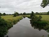 This is the river Axe. You cross the river to reach the Coach House and there are footpaths all along the banks.