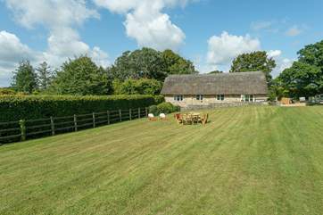 Old Sandpitts Lodge is an historic stone and thatch building with a lovely south-facing garden.