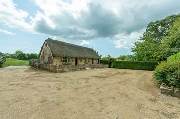 As you can see, you have plenty of parking space. The lawns are behind the cottage.