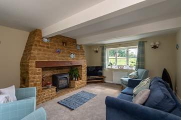 There is a beautifully furnished sitting-room with an ornamental fireplace.