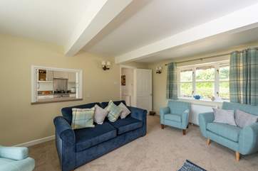 This is another view of the sitting-room which has windows to both sides.