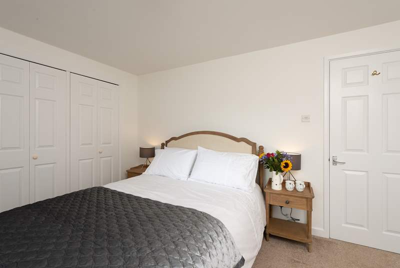 This is the master bedroom which has a king-size bed and plenty of storage space.