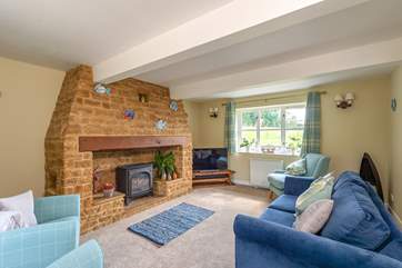 There is a beautifully furnished sitting-room with an ornamental fireplace.