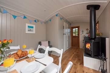 The interior is delightful, complete with dining-area for four and a warming wood-burner, an accompaniment to the under-floor heating, ensuring year-round cosiness.