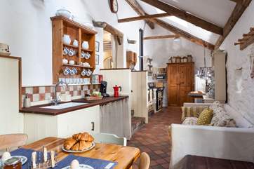 The cottage kitchen/diner is full of charm and character. Three reclaimed brick steps lead up to the sitting-room.