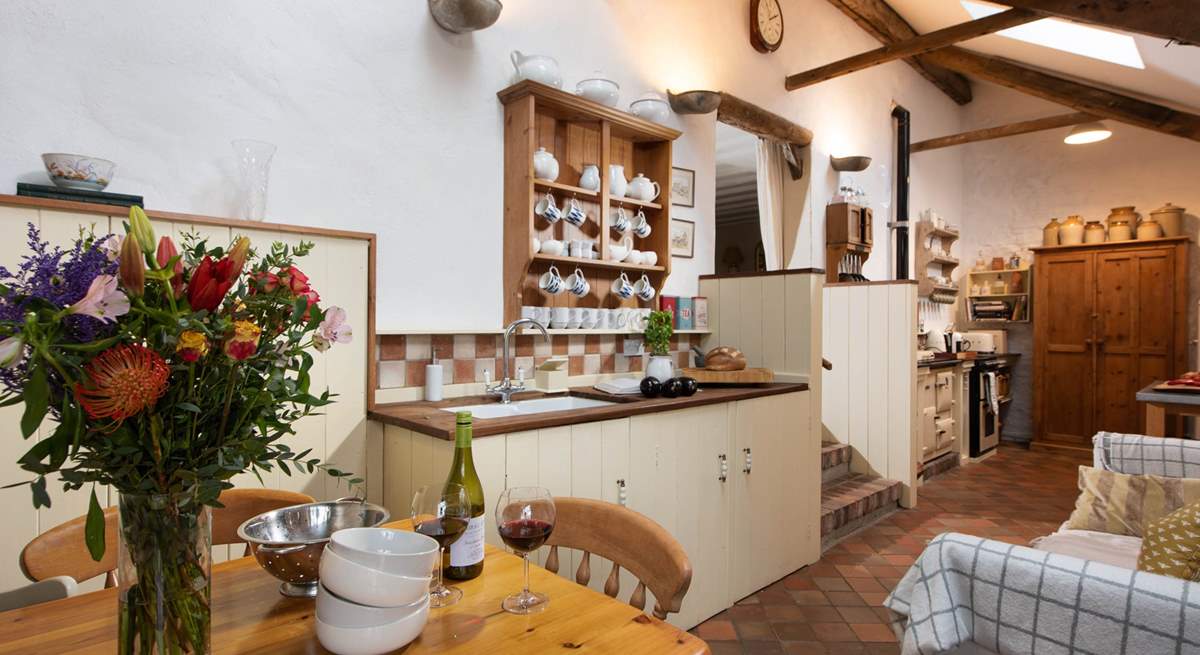 The cottage kitchen/diner is full of charm and character. Three reclaimed brick steps lead up to the sitting-room.