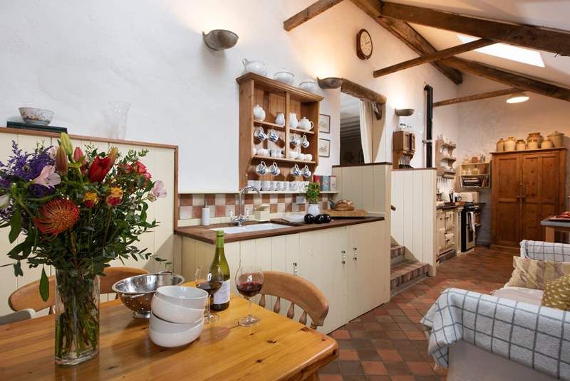 The cottage kitchen/diner is full of charm and character. Three reclaimed brick steps lead up to the sitting-room.