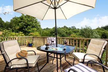 The elevated decking provides a bird's eye view of the surrounding woodland and countryside.