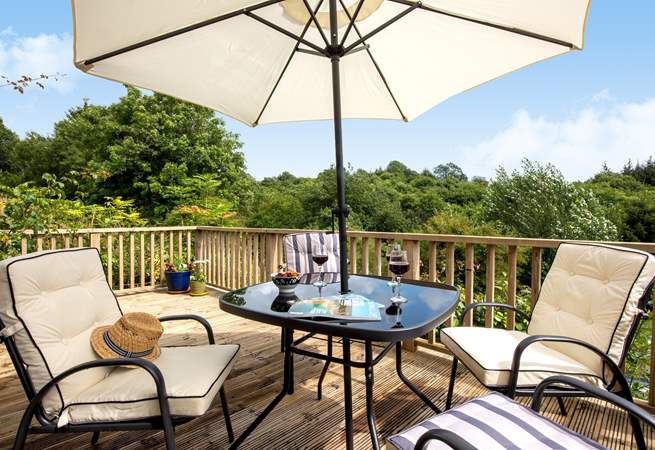 The elevated decking provides a bird's eye view of the surrounding woodland and countryside.